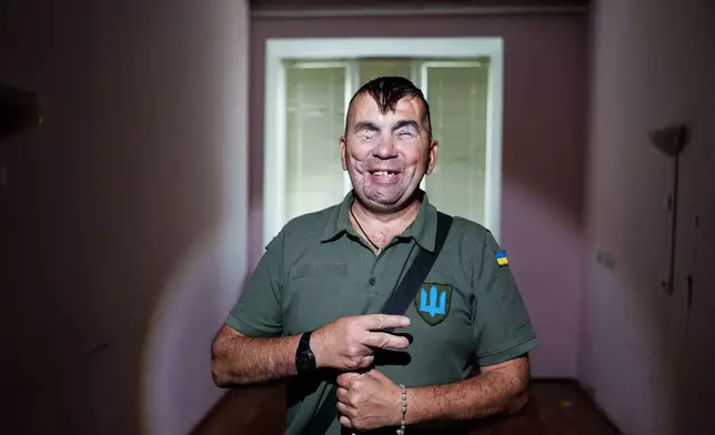 Wounded soldier Mykola Kasiuk smiles as he poses for a photo ahead of surgery at a hospital in Kyiv, Ukraine, Monday, Sept. 28, 2026. (AP Photo/Evgeniy Maloletka)