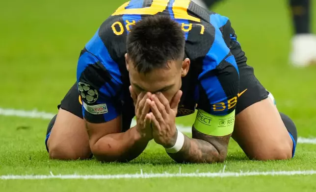 Inter Milan's Lautaro Martinez reacts after missing a scoring chance during the Champions League opening phase soccer match between Inter Milan and Club Brugge in Milan, Italy, Tuesday, Oct. 13, 2026. (AP Photo/Luca Bruno)
