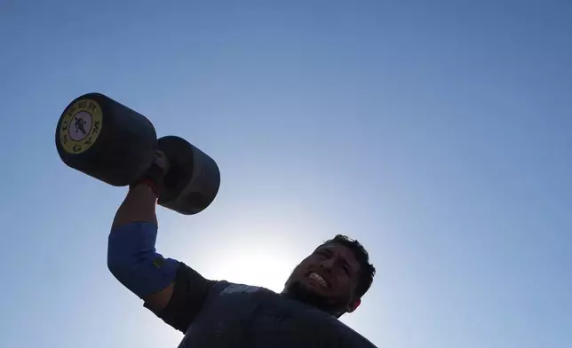 A Palestinian competitor lifts a dumbbell during the Palestine Strongman Championship in Gaza City, Friday, Oct. 16, 2026. (AP Photo/Jehad Alshrafi)