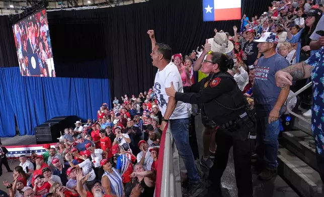 Police remove a protester as President Donald Trump speaks at a campaign rally at the Freeman Coliseum in San Antonio, Wednesday, Oct. 7, 2026. (AP Photo/Alex Brandon)