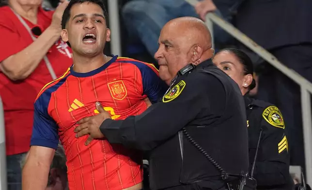 Police remove a protester as President Donald Trump speaks at a campaign rally at the Freeman Coliseum in San Antonio, Wednesday, Oct. 7, 2026. (AP Photo/Eric Gay)