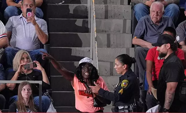 Police remove a protester as President Donald Trump speaks at a campaign rally at the Freeman Coliseum in San Antonio, Wednesday, Oct. 7, 2026. (AP Photo/Alex Brandon)