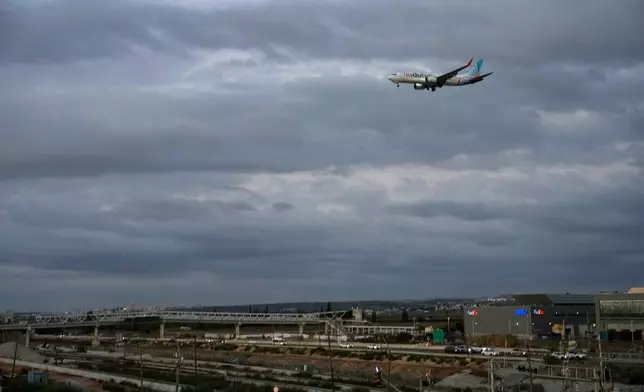An FlyDubai plane carrying Israeli passengers who had earlier been aboard another FlyDubai aircraft that made an emergency landing in Saudi Arabia approaches Ben Gurion International Airport near Tel Aviv, Israel, Wednesday, Sept. 30, 2026. (AP Photo/Ohad Zwigenberg)