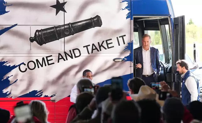 Republican U.S. Senate candidate Texas Attorney General Ken Paxton, right, arrives to speak at an event kicking off his campaign's bus tour at the Rockwall Municipal Airport Saturday, Oct. 17, 2026, in Rockwall, Texas. (AP Photo/Tony Gutierrez)