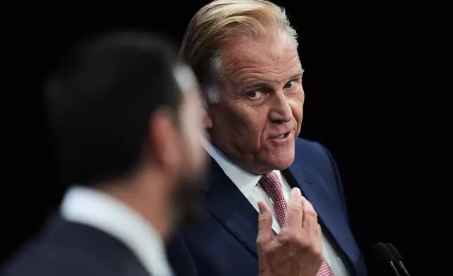 Republican nominee for U.S. Senate Mike Rogers, right, responds to Democratic nominee for U.S. Senate Abdul El-Sayed, during a televised debate at WOOD-TV, on Thursday, Oct. 8, 2026, in Grand Rapids, Mich. (AP Photo/Paul Sancya, Pool)