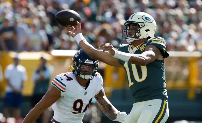 Green Bay Packers' Jordan Love throws past Chicago Bears' Austin Booker during the first half of an NFL football game in Green Bay, Wis., Sunday, Oct. 11, 2026. (AP Photo/Mike Roemer)