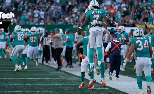 Miami Dolphins wide receiver Caleb Douglas celebrates his touchdown against the New York Jets in the second half of an NFL football game in East Rutherford, N.J., Sunday, Oct. 25, 2026. (AP Photo/Seth Wenig)