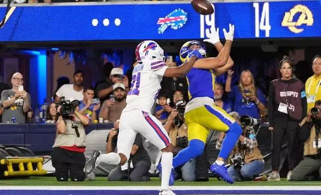 Los Angeles Rams wide receiver Puka Nacua, right, makes a touchdown catch as Buffalo Bills cornerback Davison Igbinosun defends during the second half of an NFL football game, Monday, Oct. 12, 2026, in Inglewood, Calif. (AP Photo/Gregory Bull)