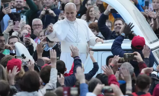 Pope Leo XIV waves as he arrives for his weekly general audience in St. Peter's Square at The Vatican, Wednesday, Oct. 21, 2026. (AP Photo/Gregorio Borgia)