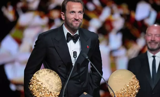 England's soccer player Harry Kane wins the trophy for striker of the year during the Ballon d'Or ceremony at the London Palladium Theatre in London, England, Monday, Oct. 26, 2026 . (AP Photo/Kin Cheung)