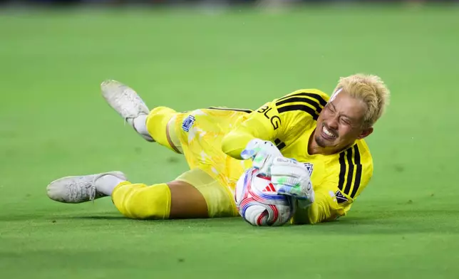 Vancouver Whitecaps FC goalkeeper Yohei Takaoka (1) dives for the ball during the first half of an MLS soccer match against the Los Angeles Football Club in Los Angeles, Saturday, Oct. 10, 2026. (AP Photo/Kyusung Gong)