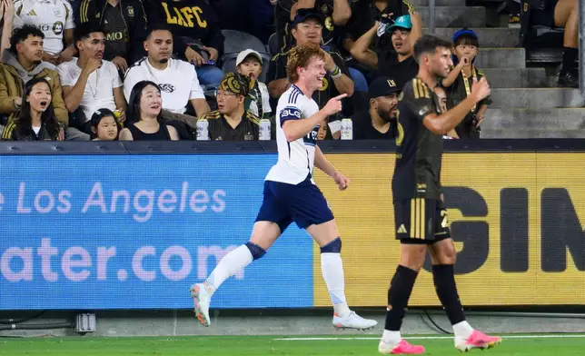 Vancouver Whitecaps FC midfielder Oliver Larraz, left, celebrates his goal during the first half of an MLS soccer match against the Los Angeles Football Club in Los Angeles, Saturday, Oct. 10, 2026. (AP Photo/Kyusung Gong)