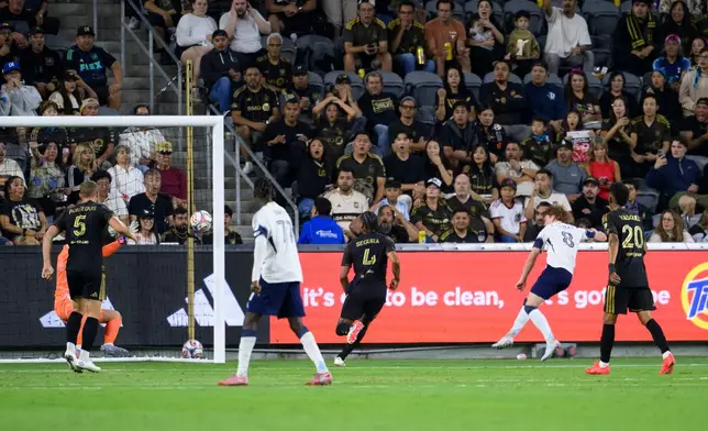 Vancouver Whitecaps FC midfielder Oliver Larraz (8) shoots for a goal during the first half of an MLS soccer match against the Los Angeles Football Club in Los Angeles, Saturday, Oct. 10, 2026. (AP Photo/Kyusung Gong)