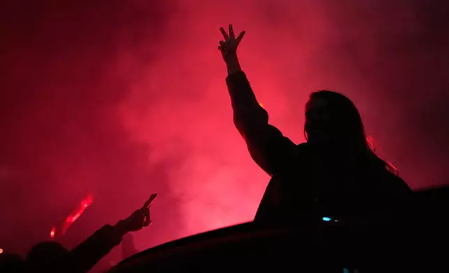 People celebrate after Aleksandar Vucic, leader of the right-wing Serbian Progressive Party (SNS) conceded defeat in the parliamentary election in Belgrade, Serbia, Sunday, Oct. 25, 2026. (AP Photo/Petr David Josek)