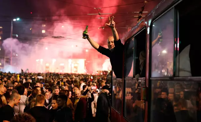 People celebrate after Aleksandar Vucic, leader of the right-wing Serbian Progressive Party (SNS) conceded defeat in the parliamentary election in Belgrade, Serbia, Sunday, Oct. 25, 2026. (AP Photo/Marko Drobnjakovic)