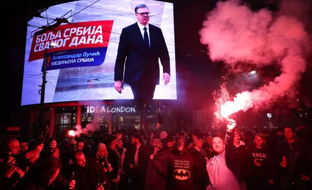 People celebrate after Aleksandar Vucic, leader of the right-wing Serbian Progressive Party (SNS) , seen on the top display, conceded defeat in the parliamentary election in Belgrade, Serbia, Sunday, Oct. 25, 2026. (AP Photo/Armin Durgut)