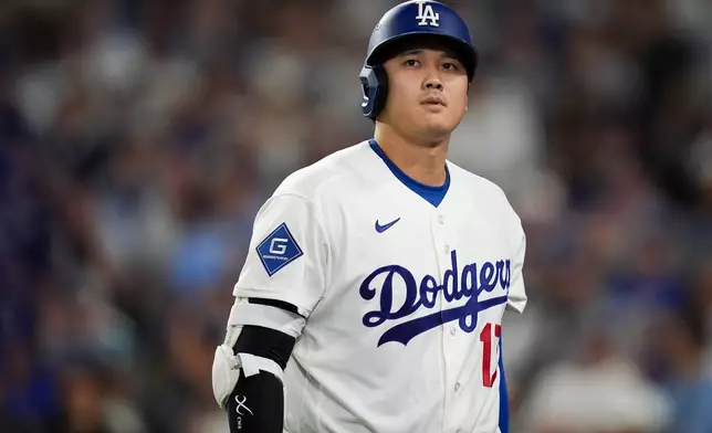 Los Angeles Dodgers designated hitter Shohei Ohtani walks to the dugout after striking out during the seventh inning of Game 4 of baseball's National League Championship Series between the Milwaukee Brewers and the Los Angeles Dodgers, Thursday, Oct. 15, 2026, in Los Angeles. (AP Photo/Gregory Bull)