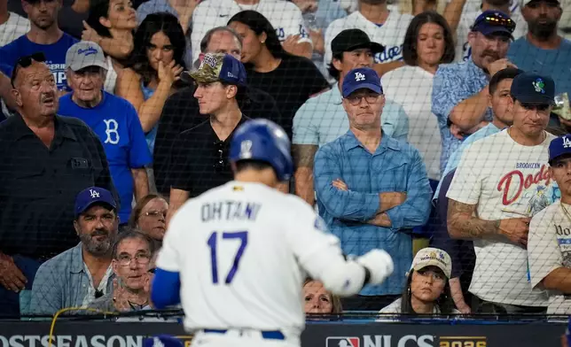 Fans watch as Los Angeles Dodgers designated hitter Shohei Ohtani walks to the dugout after striking out during the seventh inning of Game 4 of baseball's National League Championship Series between the Milwaukee Brewers and the Los Angeles Dodgers, Thursday, Oct. 15, 2026, in Los Angeles. (AP Photo/Ashley Landis)