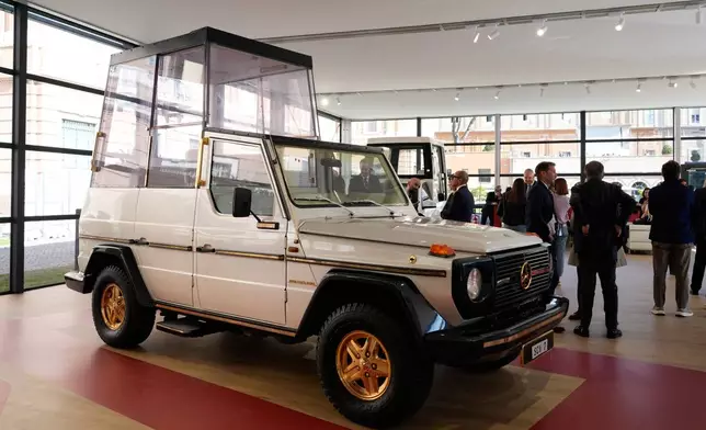 A popemobile used by successive popes is displayed at "A Century of the Popemobile," an exhibition tracing 100 years of papal transportation, from Pope Pius XI's first automobile in 1930 to modern popemobiles, at the Vatican Museums, Wednesday, Oct. 28, 2026. (AP Photo/Isaia Montelione)