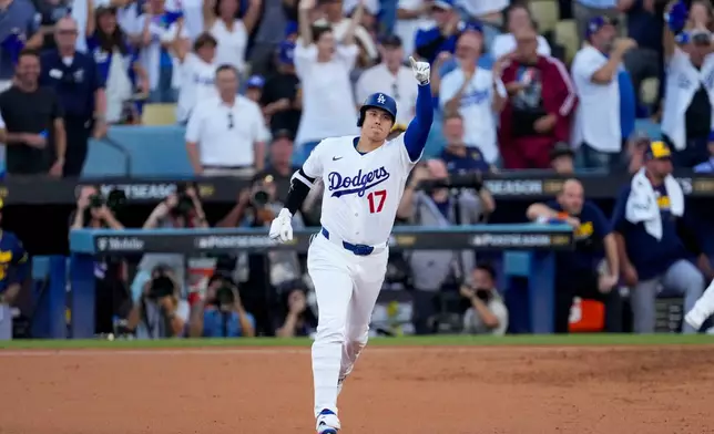 Los Angeles Dodgers designated hitter Shohei Ohtani celebrates his three run home run during the second inning of Game 4 of baseball's National League Championship Series between the Milwaukee Brewers and the Los Angeles Dodgers, Thursday, Oct. 15, 2026, in Los Angeles (AP Photo/Mark J. Terrill)