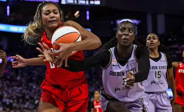 Atlanta Dream forward Naz Hillmon, left, and Golden State Valkyries forward Laeticia Amihere (3) go for the ball during the second half of Game 2 of the WNBA basketball finals, Monday, Oct. 19, 2026, in San Francisco. (AP Photo/Justine Willard)