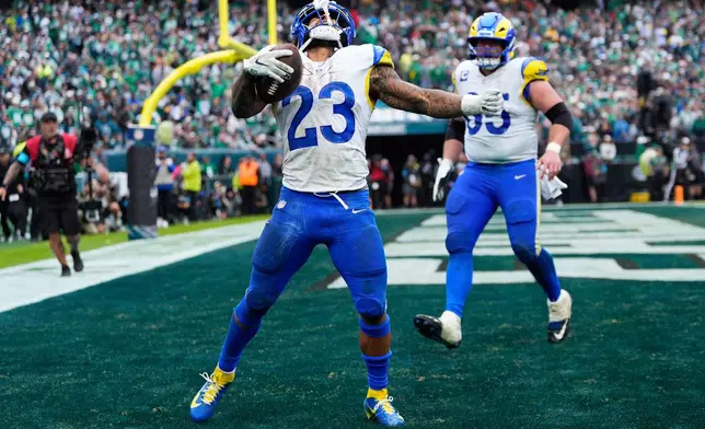 Los Angeles Rams running back Kyren Williams (23) celebrates scoring a touchdown during the second half of an NFL football game against the Philadelphia Eagles in Philadelphia, Sunday, Oct. 4, 2026. (AP Photo/Chris Szagola)