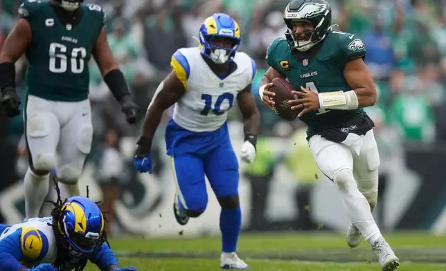 Philadelphia Eagles quarterback Jalen Hurts (1) runs with the ball during the second half of an NFL football game against the Los Angeles Rams in Philadelphia, Sunday, Oct. 4, 2026. (AP Photo/Matt Slocum)