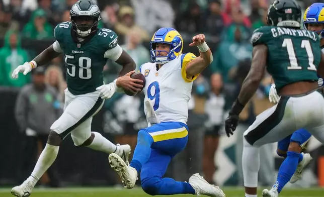 Los Angeles Rams quarterback Matthew Stafford (9) falls with the ball during the second half of an NFL football game against the Los Angeles Rams in Philadelphia, Sunday, Oct. 4, 2026. (AP Photo/Matt Slocum)