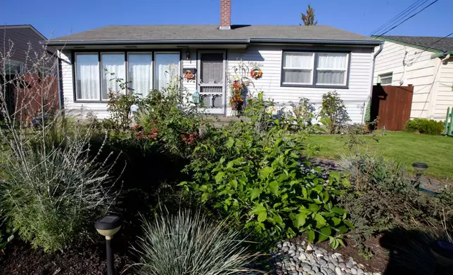FILE - A rain garden appears in a residential area of Puyallup, Wash., on Oct. 18, 2011. (AP Photo/Ted S. Warren, File)