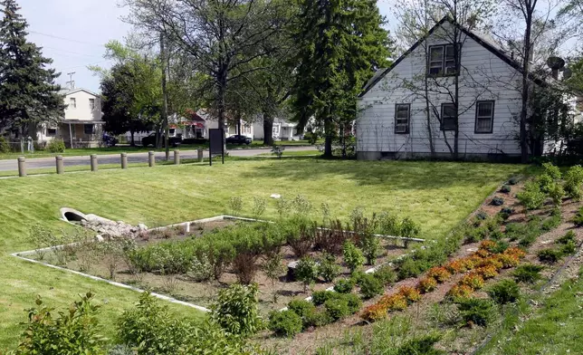 FILE - A bioretention garden built to collect rain runoff appears at a home in the Warrendale neighborhood of Detroit on May 16, 2016. (AP Photo/Carlos Osorio, File)