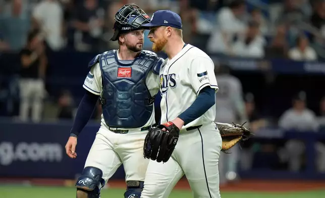 Tampa Bay Rays pitcher Drew Rasmussen, right, and catcher Liam Hicks walk to the dugout after retiring the New York Yankees during the seventh inning of Game 1 of an American League Division Series baseball game Saturday, Oct. 3, 2026, in St. Petersburg, Fla. (AP Photo/Chris O'Meara)