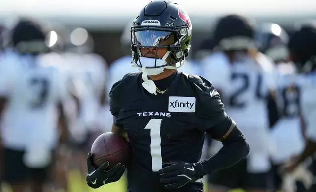 FILE - Houston Texans wide receiver Tank Dell works out during the team's NFL football training camp in Houston, Aug. 7, 2026. (AP Photo/Ashley Landis, File)
