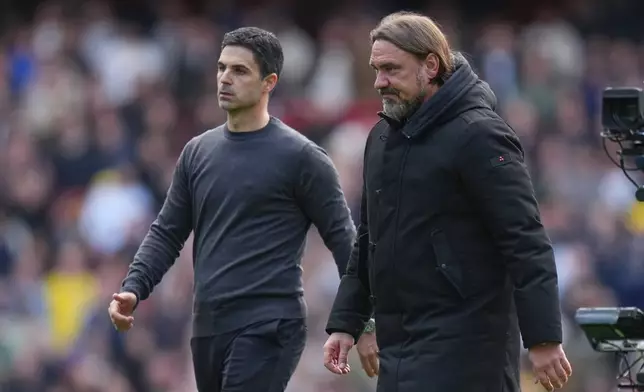 Arsenal's manager Mikel Arteta, left, leaves the field with Leeds' head coach Daniel Farke at the end of the English Premier League soccer match between Arsenal and Leeds United in London, Saturday, Oct. 10, 2026. (AP Photo/Alastair Grant)