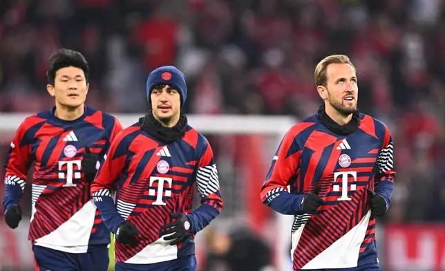 Munich's Harry Kane, right, the men's Ballon d'Or winner, and teammates Min-jae Kim, left, and Aleksandar Pavlovic warm up before the German Cup soccer game between Bayern Munich and 1. FC Magdeburg, Wednesday, Oct. 28, 2026, in Munich, Germany. (Sven Hoppe/dpa via AP)