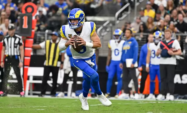 Los Angeles Rams quarterback Matthew Stafford rolls out looking to pass against the Las Vegas Raiders during the first half of an NFL football game Sunday, Oct. 25, 2026, in Las Vegas. (AP Photo/David Becker)