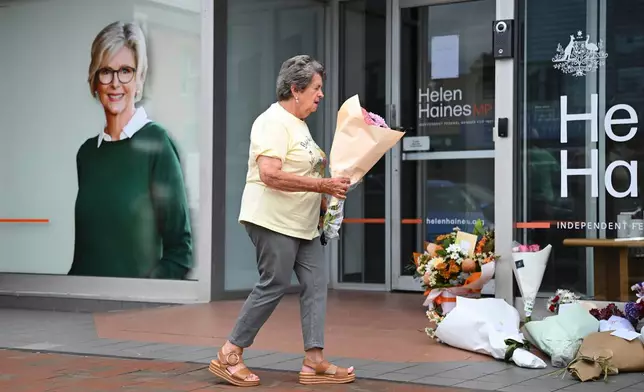 A woman delivers flowers at the electoral office of independent member of parliament, Helen Haines, in Wangaratta, Australia, Tuesday, Oct. 20, 2026. (James Ross/AAP Image via AP)