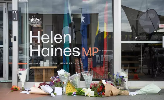 Tributes and flowers are placed outside the electoral office for independent member of parliament Helen Haines in Wangaratta, Australia, Tuesday, Oct. 20, 2026. (James Ross/AAPImage via AP)