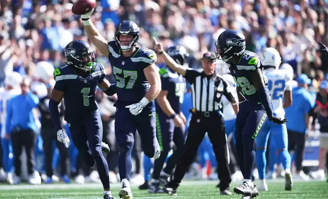 Seattle Seahawks linebacker Connor O'Toole (57) celebrates after recovering a fumble during the first half of an NFL football game against the Los Angeles Chargers, Sunday, Oct. 4, 2026, in Seattle. (AP Photo/Lindsey Wasson)