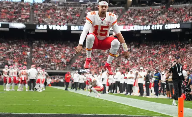 Kansas City Chiefs quarterback Patrick Mahomes (15) jumps into the air before an NFL football game against the Las Vegas Raiders in Las Vegas, Sunday, Oct. 4, 2026. (AP Photo/Rick Scuteri)