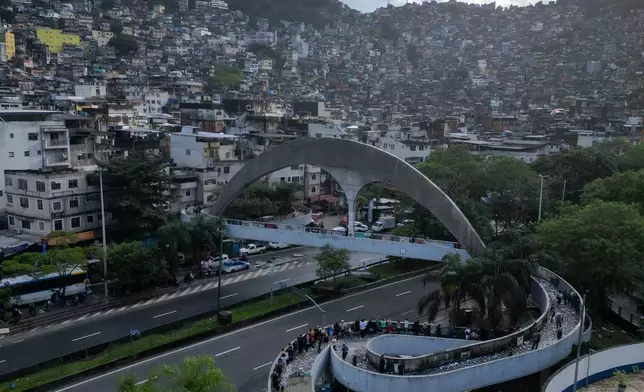 Voters line up to cast their ballots during general elections in the Rocinha favela in Rio de Janeiro, Brazil, Sunday, Oct. 4, 2026. (AP Photo/Bruna Prado)
