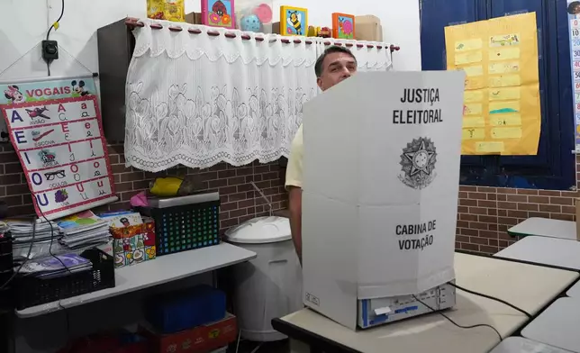 Opposition presidential candidate Sen. Flavio Bolsonaro votes during general elections in Rio de Janeiro, Sunday, Oct. 4, 2026. (AP Photo/Silvia Izquierdo)