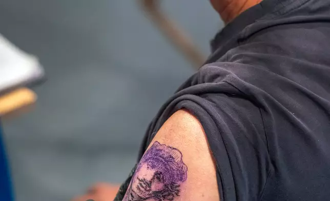 Tattoo artist Henk Schiffmacher tattoos a self-portrait of Dutch artist Rembrandt onto the arm of Associated Press journalist Mike Corder in a studio in the Rembrandt House Museum in Amsterdam, Tuesday, Oct. 27, 2026. (AP Photo/Patrick Post)