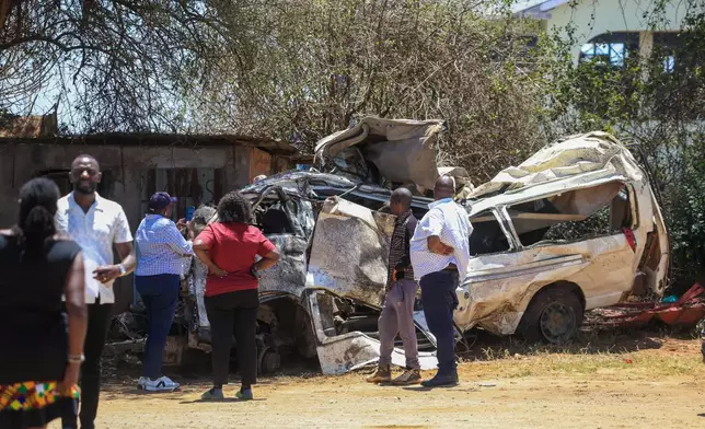 People view the wreckage of a 14-seater minibus that was involved in an accident killing all the passengers, in the Salama area, Makueni County, Eastern Kenya, Saturday, Oct. 3, 2026. (AP Photo/Andrew Kasuku)