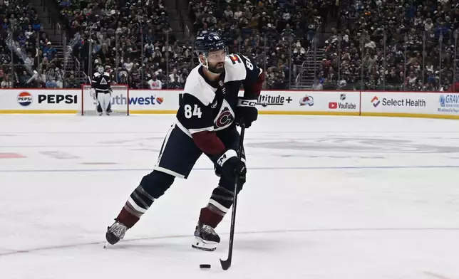 Colorado Avalanche defenseman Brent Burns controls the puck in the first period of an NHL hockey game against the St.louis Blues, Saturday, Oct. 3, 2026, in Denver. (AP Photo/RJ Sangosti)
