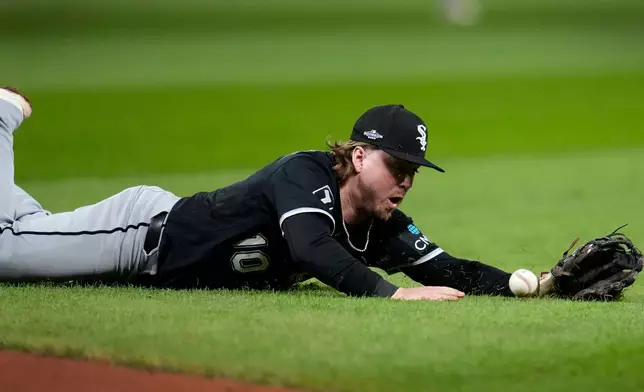 Chicago White Sox second baseman Chase Meidroth dives for a ball hit by Cleveland Guardians' Chase DeLauter during the sixth inning of Game 5 of baseball's American League Division Series, Saturday, Oct. 10, 2026, in Cleveland. (AP Photo/Sue Ogrocki)