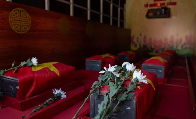 The remains of 731 martyrs' remains found at Le Thi Rieng Cultural Park are transferred for burial at Ho Chi Minh City Martyrs' Cemetery Wednesday, Oct. 14, 2026, in Ho Chi Minh City, Vietnam. (AP Photo/Thanh Hue)