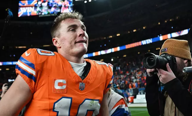 Denver Broncos quarterback Bo Nix walks on the field after a win over the Seattle Seahawks in an NFL football game in Denver, Thursday, Oct. 15, 2026. (AP Photo/Geneva Heffernan)