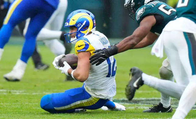 Los Angeles Rams wide receiver Puka Nacua (12) makes a catch in front of Philadelphia Eagles linebacker Jeremiah Trotter Jr. (54) during the second half of an NFL football game in Philadelphia, Sunday, Oct. 4, 2026. (AP Photo/Chris Szagola)