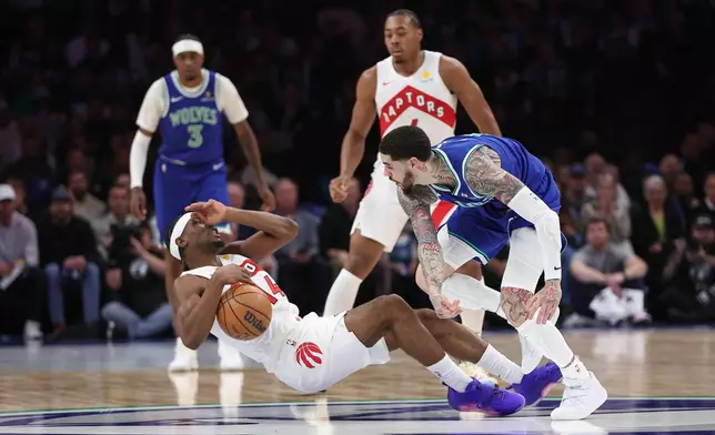 Minnesota Timberwolves guard LaMelo Ball, right, fouls Toronto Raptors guard Ja'kobe Walter, left, during the first half of an NBA basketball game, Sunday, Oct. 25, 2026, in Minneapolis. (AP Photo/Bailey Hillesheim)