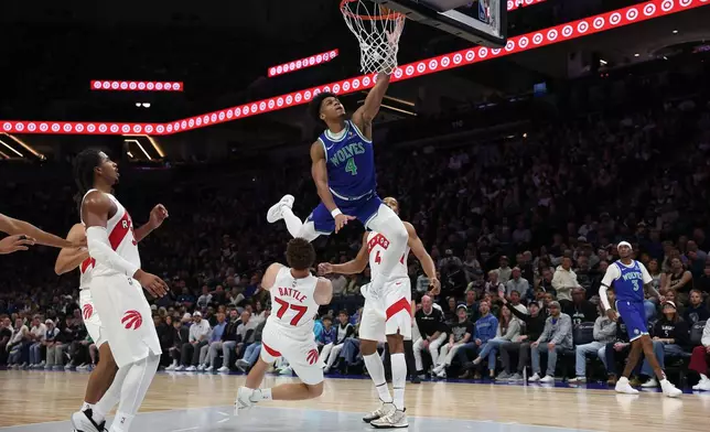 Minnesota Timberwolves guard Terrence Shannon Jr. (4) goes up for a layup over Toronto Raptors forward Jamison Battle (77) during the first half of an NBA basketball game, Sunday, Oct. 25, 2026, in Minneapolis. (AP Photo/Bailey Hillesheim)